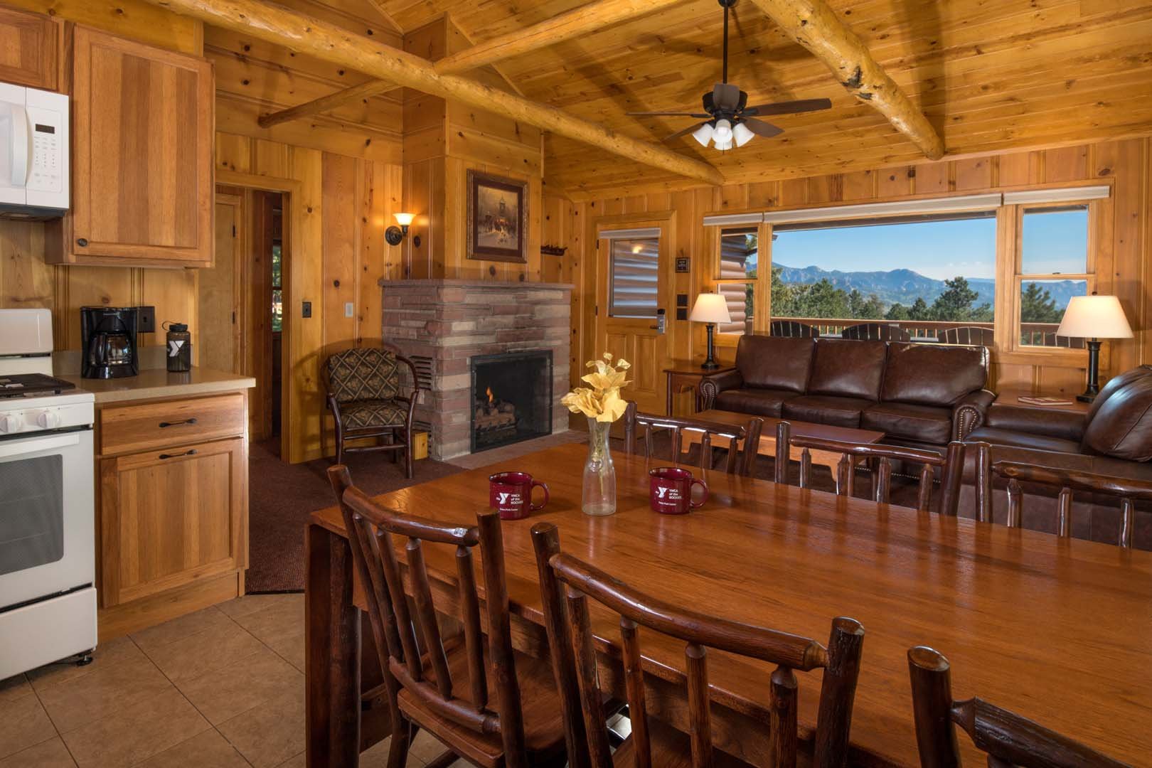 Living room with dining area, sofas, and fireplace