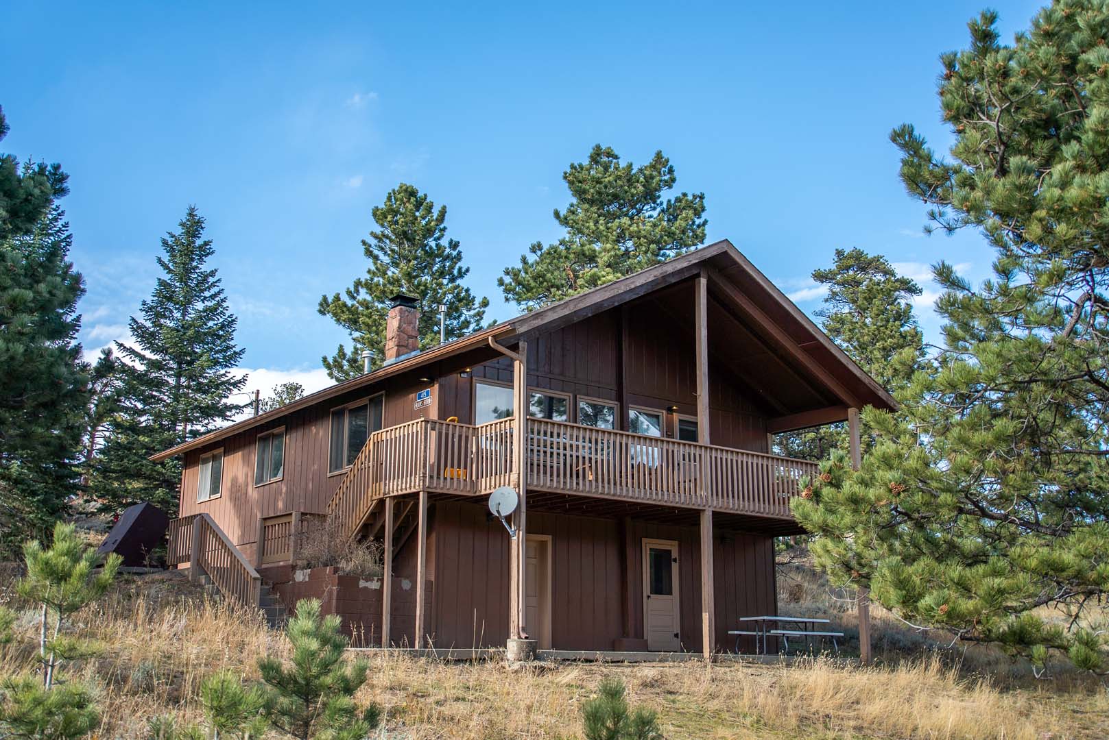 large cabin with trees in background