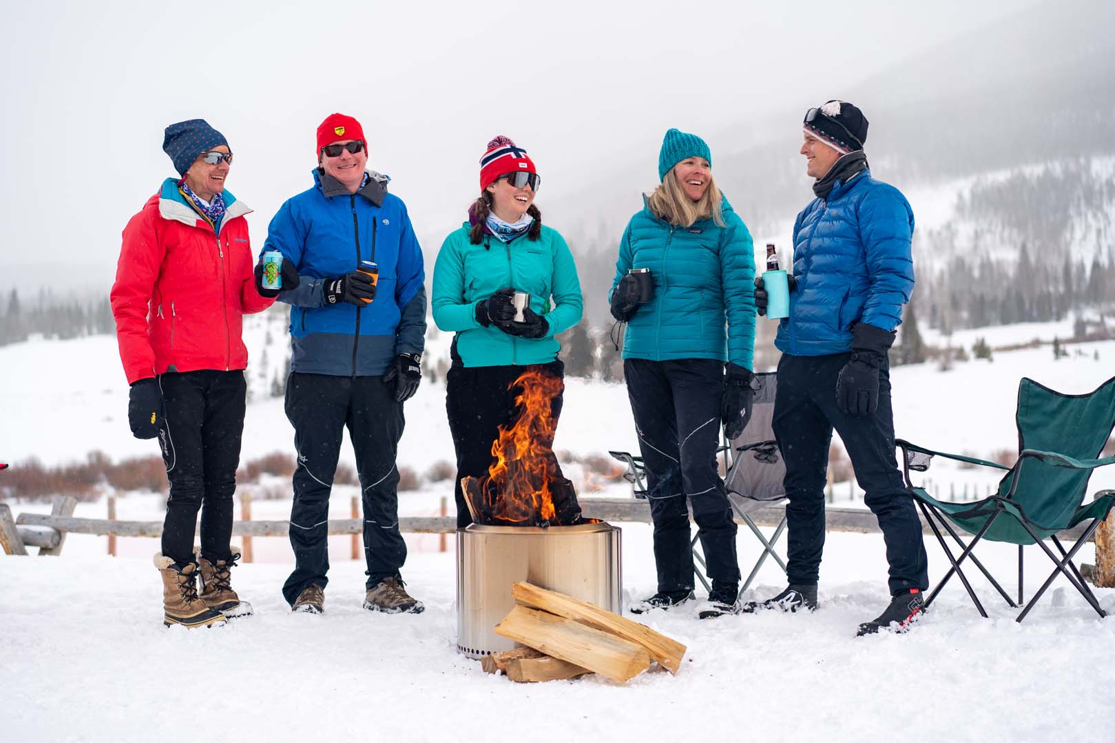 People standing around an outdoor fire pit