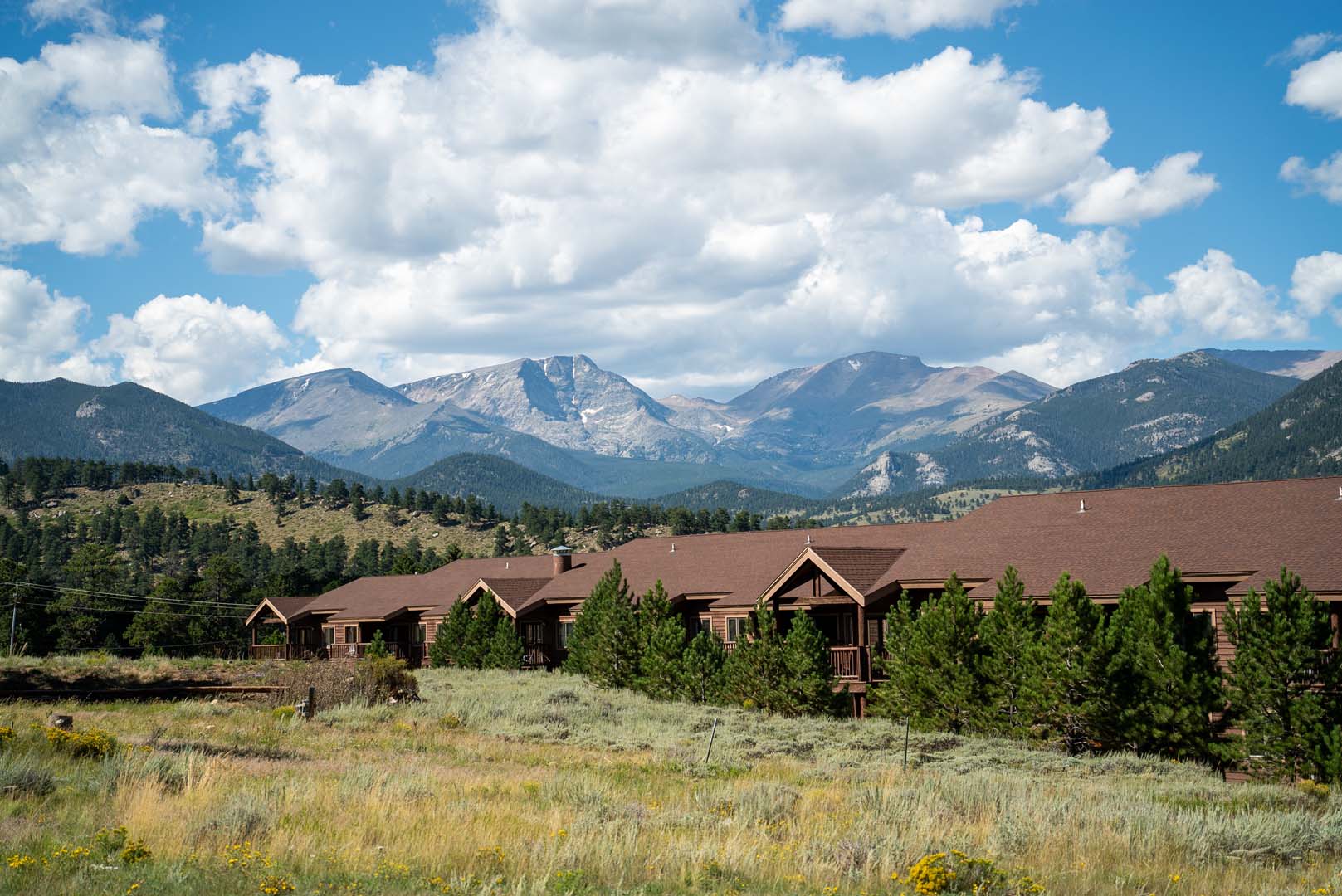 Lodge view from a distance with mountains in the background