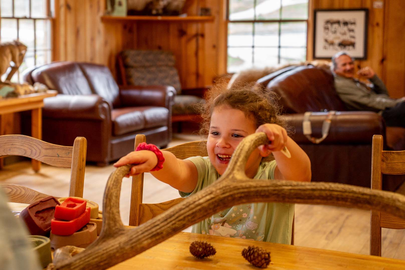 Child playing with antlers