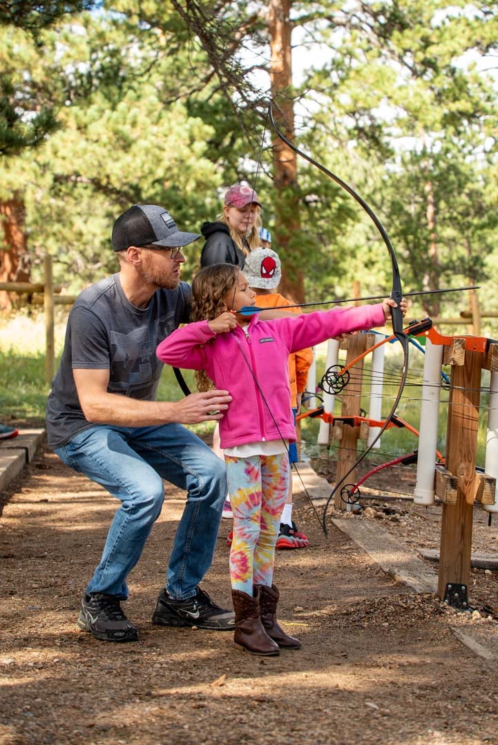 Child learning how to do archery