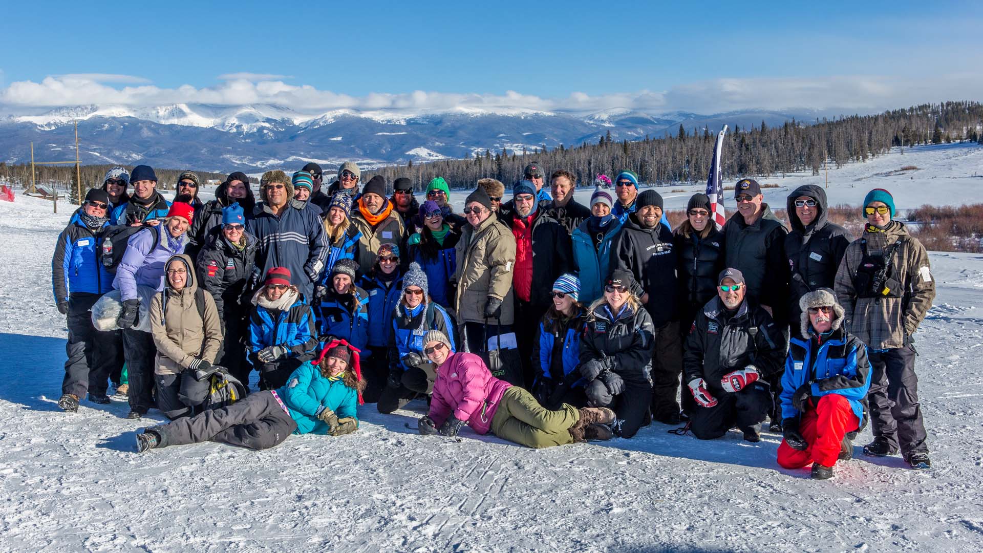 Group of people gathered outside during the winter with snow