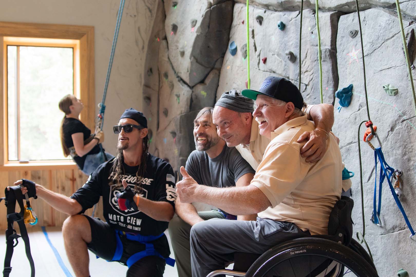 Group of people in front of rock climbing wall