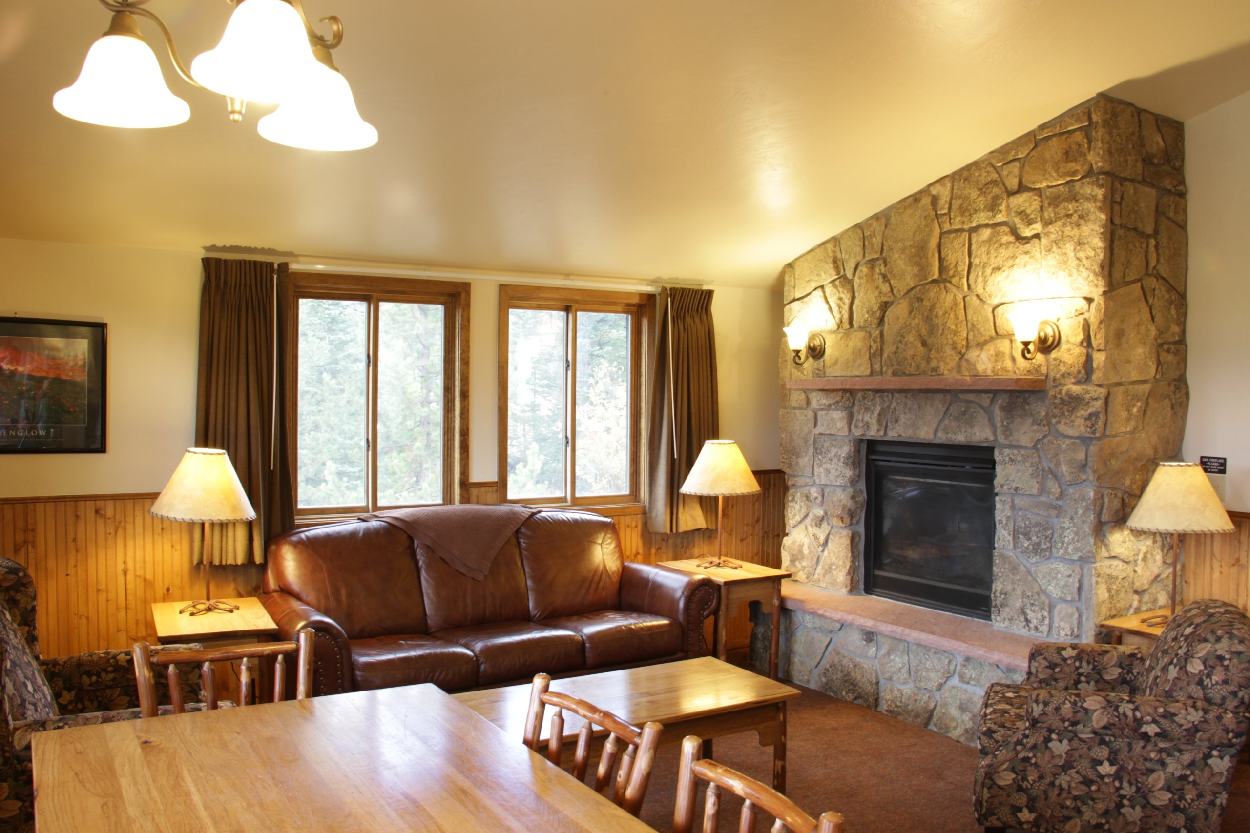 Living room with dining area, sofas, and fireplace