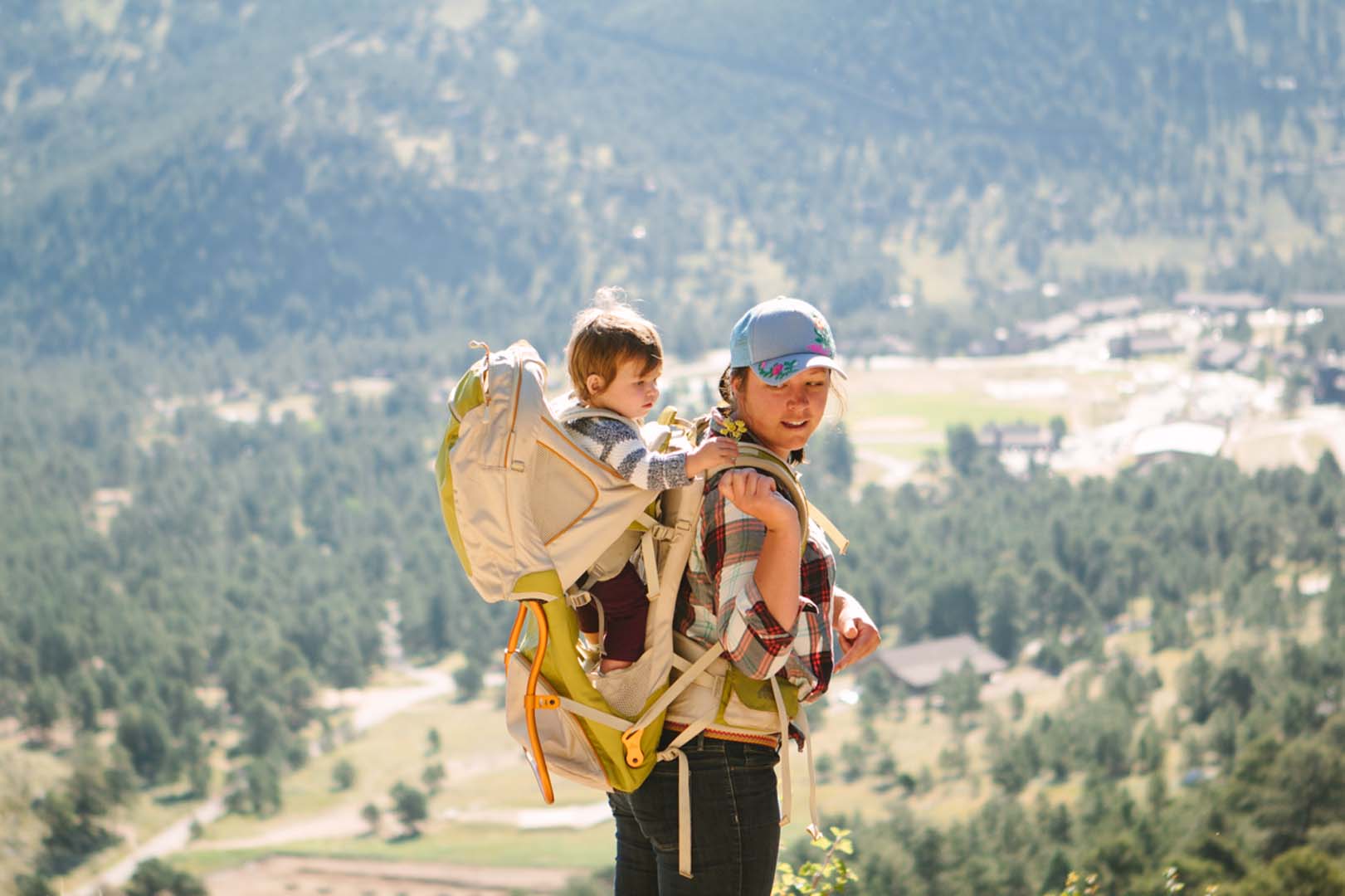 Woman hiking with her baby in a carrier backpack