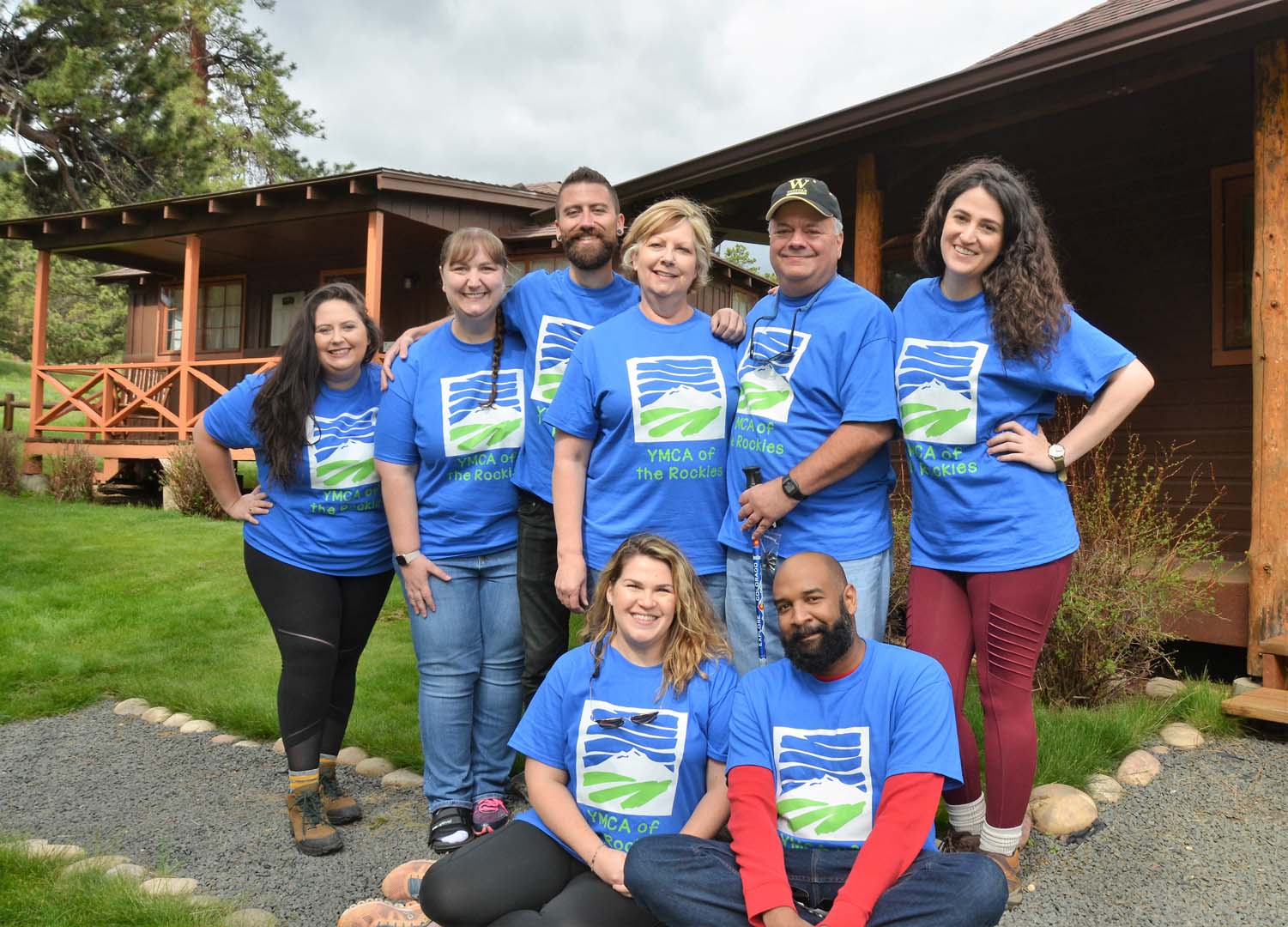 Group of people gathered outside with matching YMCA tshirts