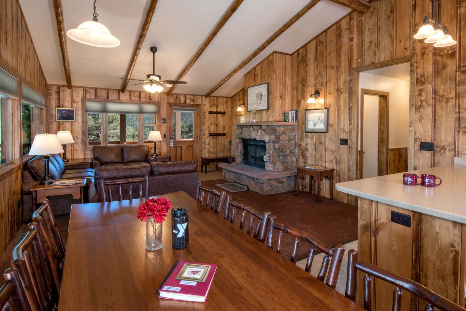 Living room with dining area, sofas, and fireplace