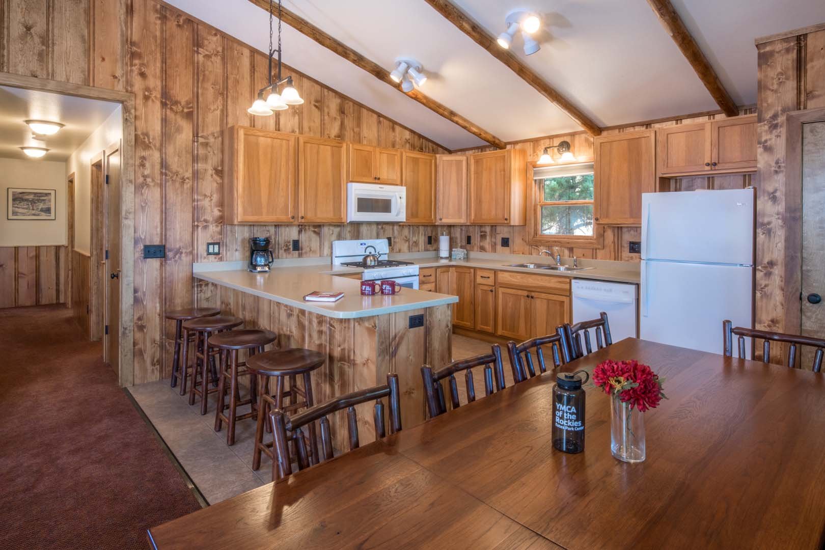 Kitchen inside cabin with kitchen island and dining table