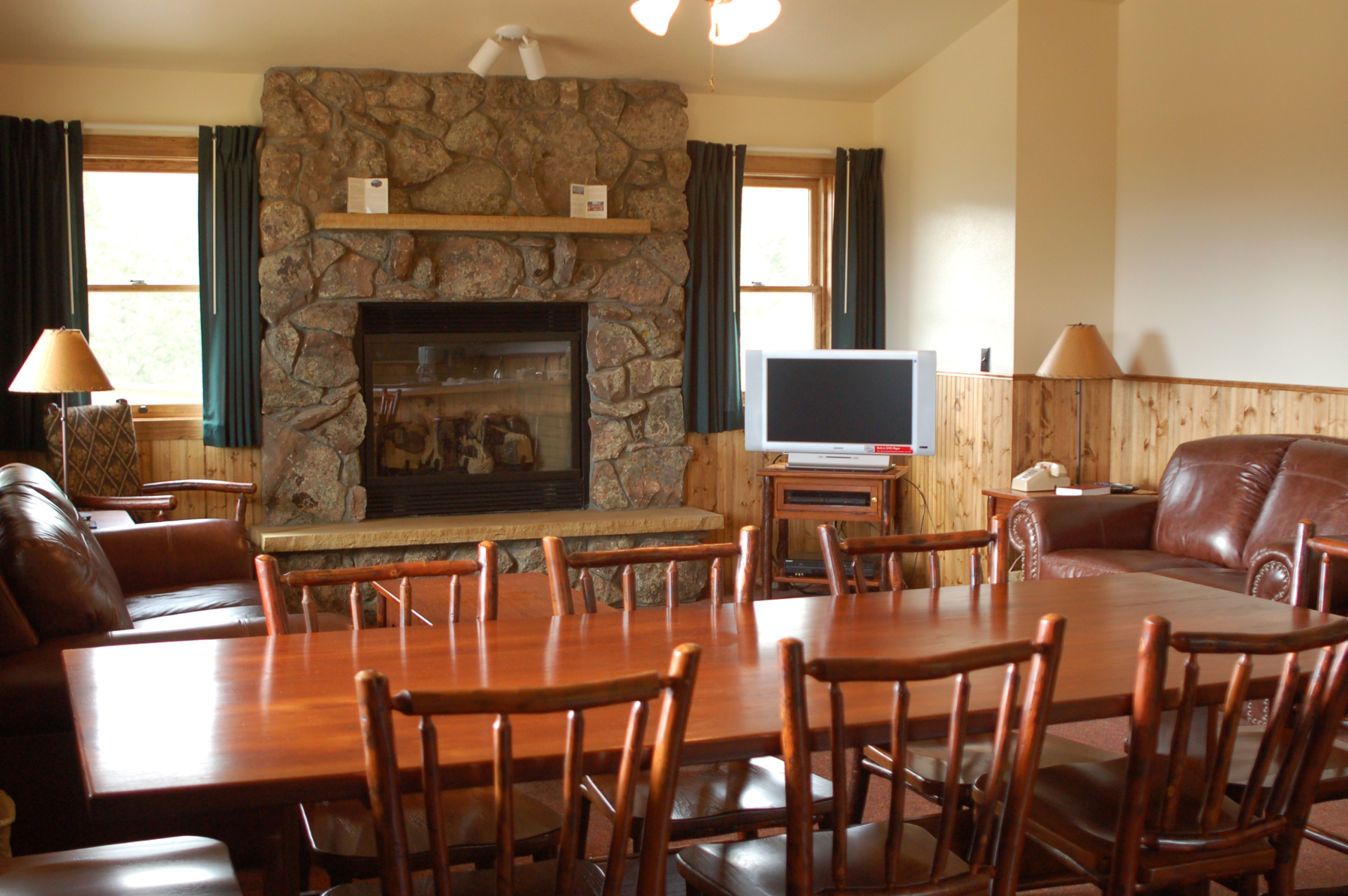 Living room with dining area, sofas, tv and fireplace