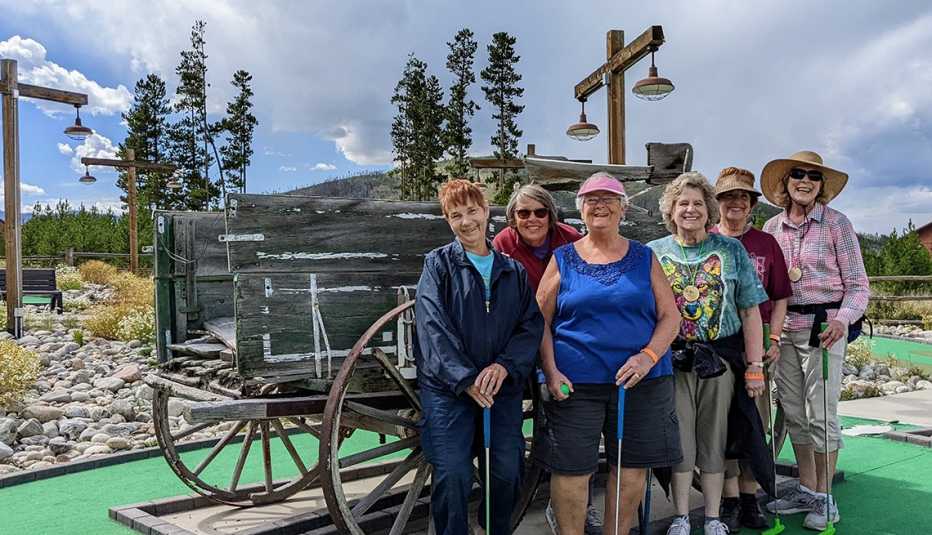 people posing for a picture on a miniature golf course