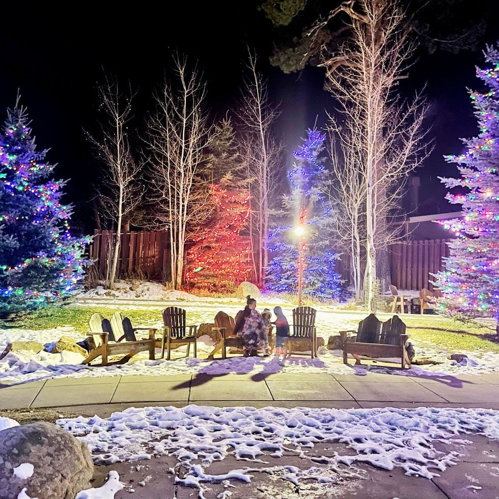 a family sitting on a bench during christmas