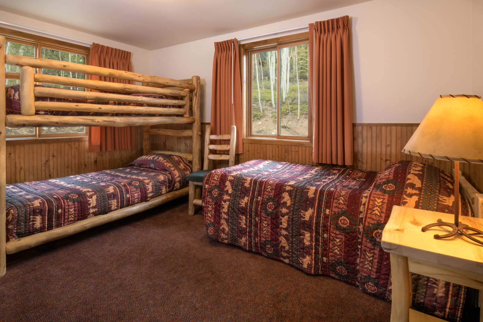 Queen bed and bunk beds in cabin