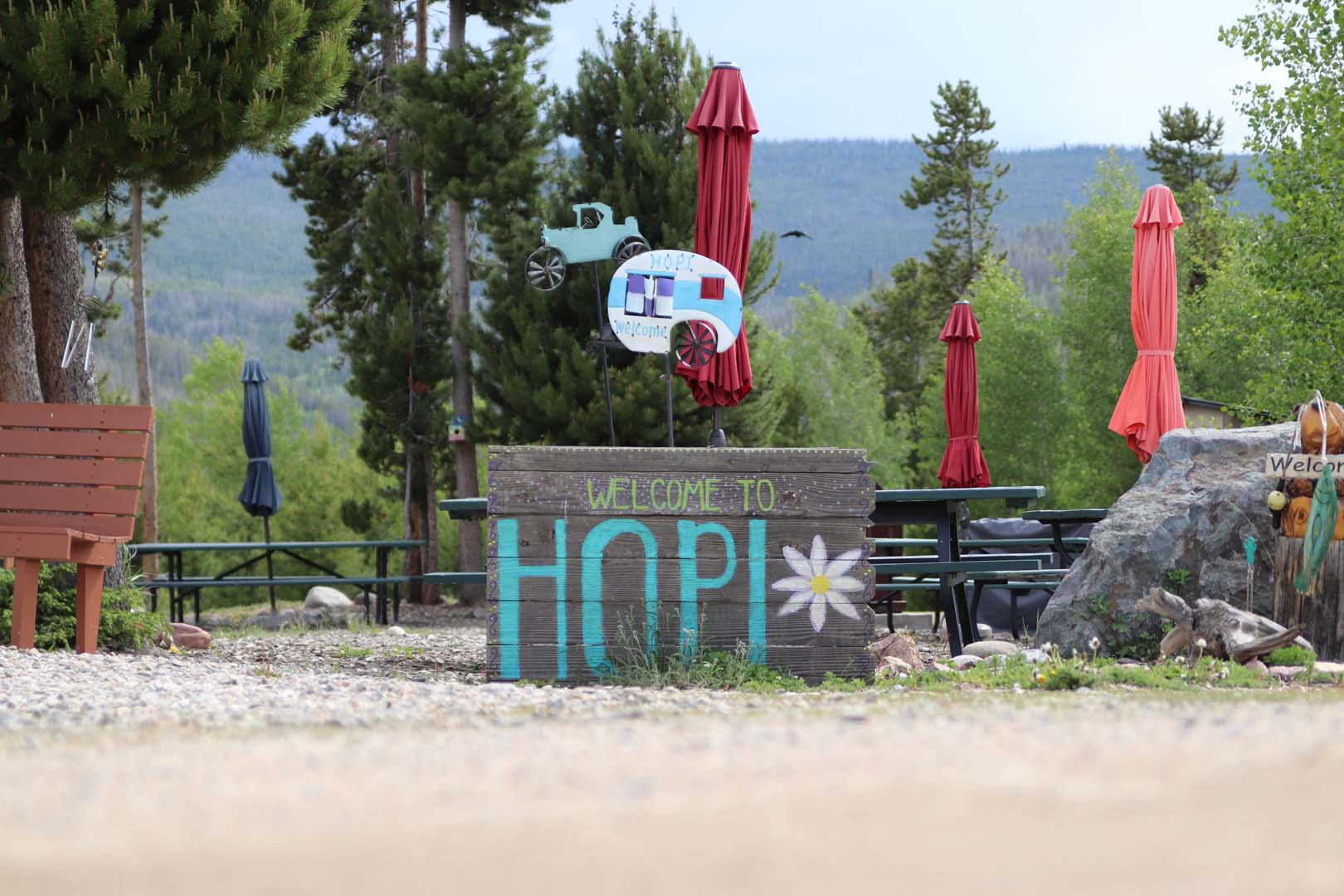 Camp hopi welcome sign with picnic benches