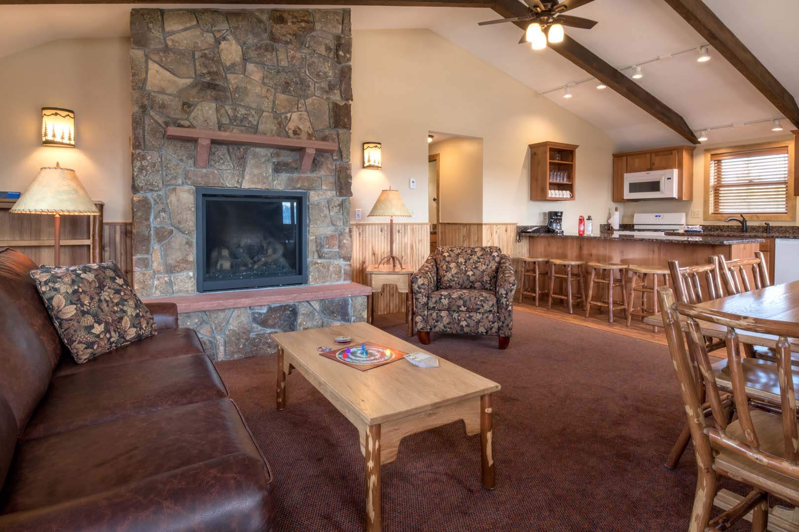 Living room with dining area, sofas, and fireplace