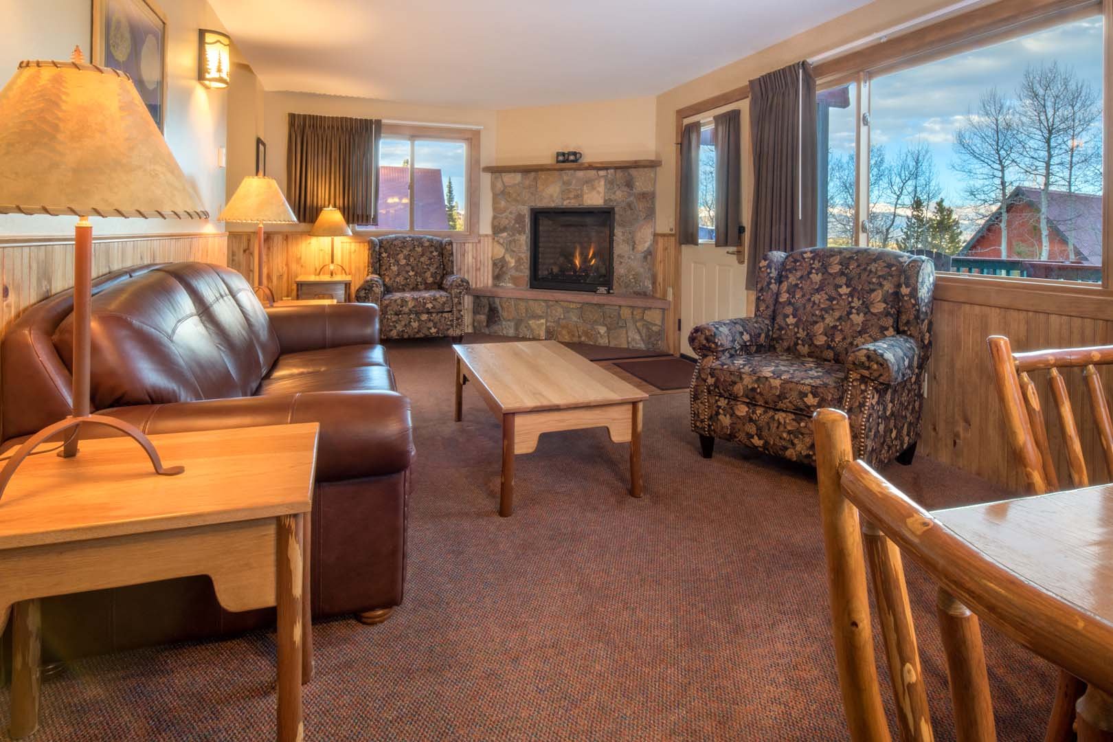 Living room with dining area, sofas, and fireplace