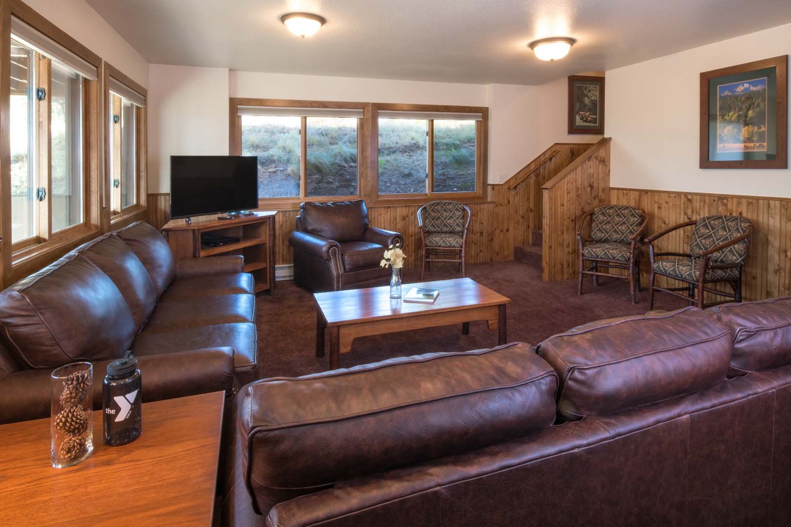 Living room with dining area, sofas, and tv