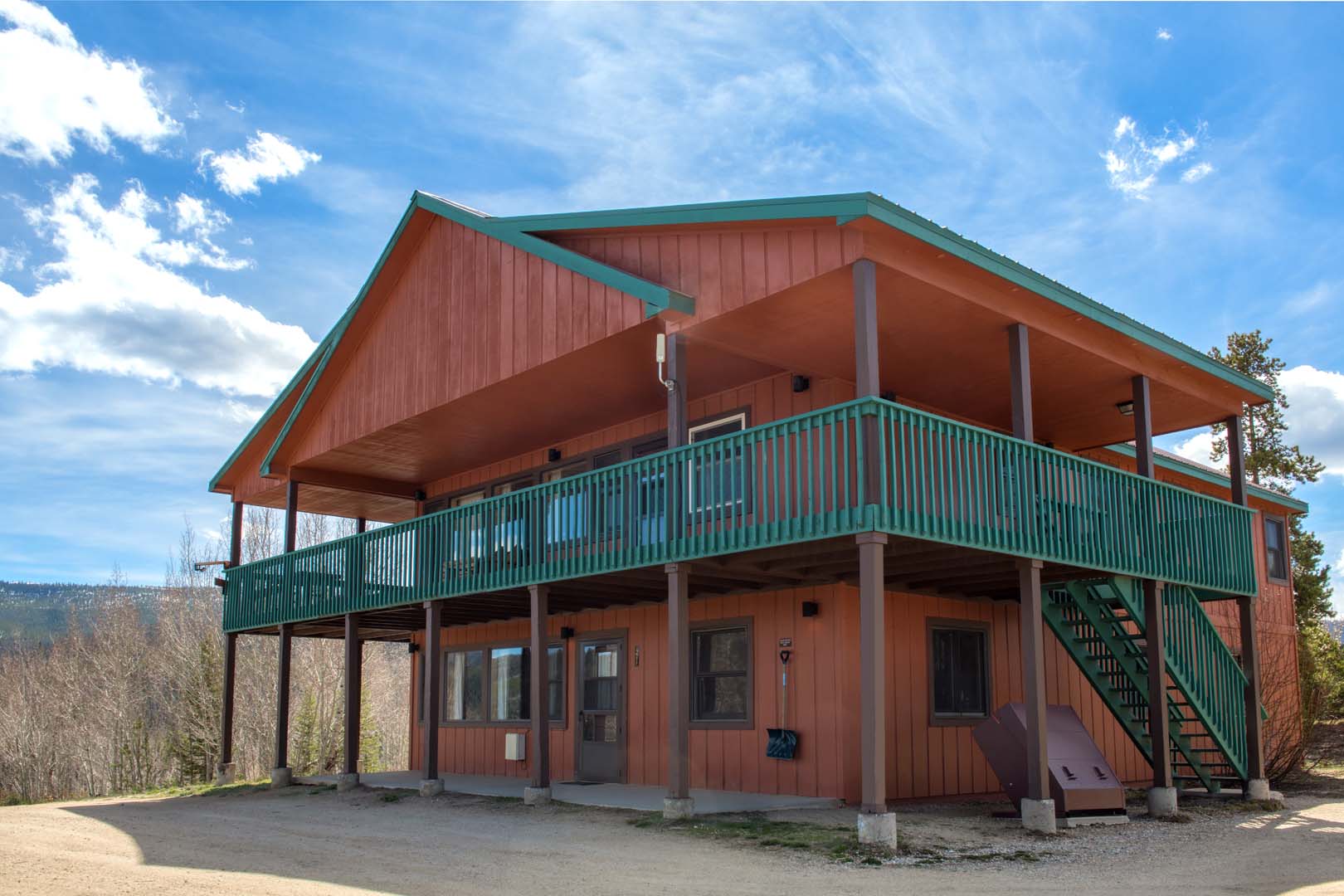 large cabin with trees in background