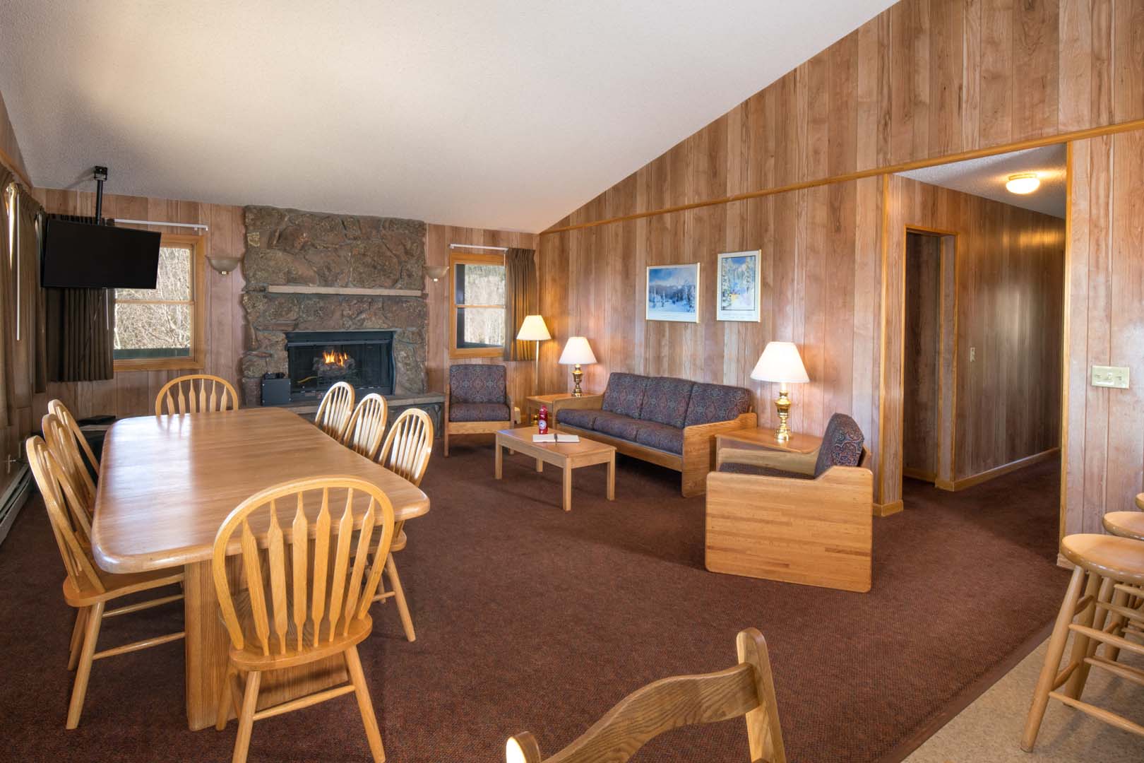 Living room with dining area, sofas, and fireplace