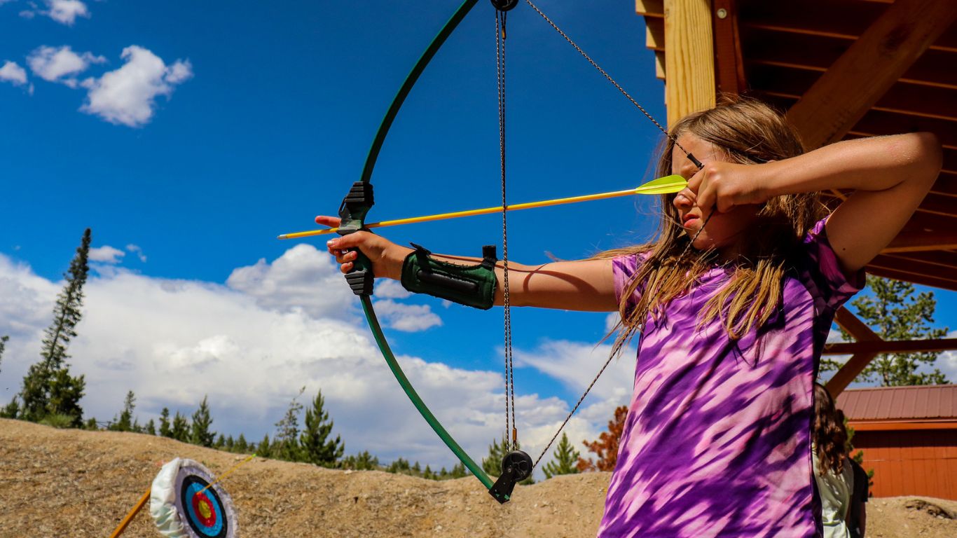 girl shooting a bow and arrow