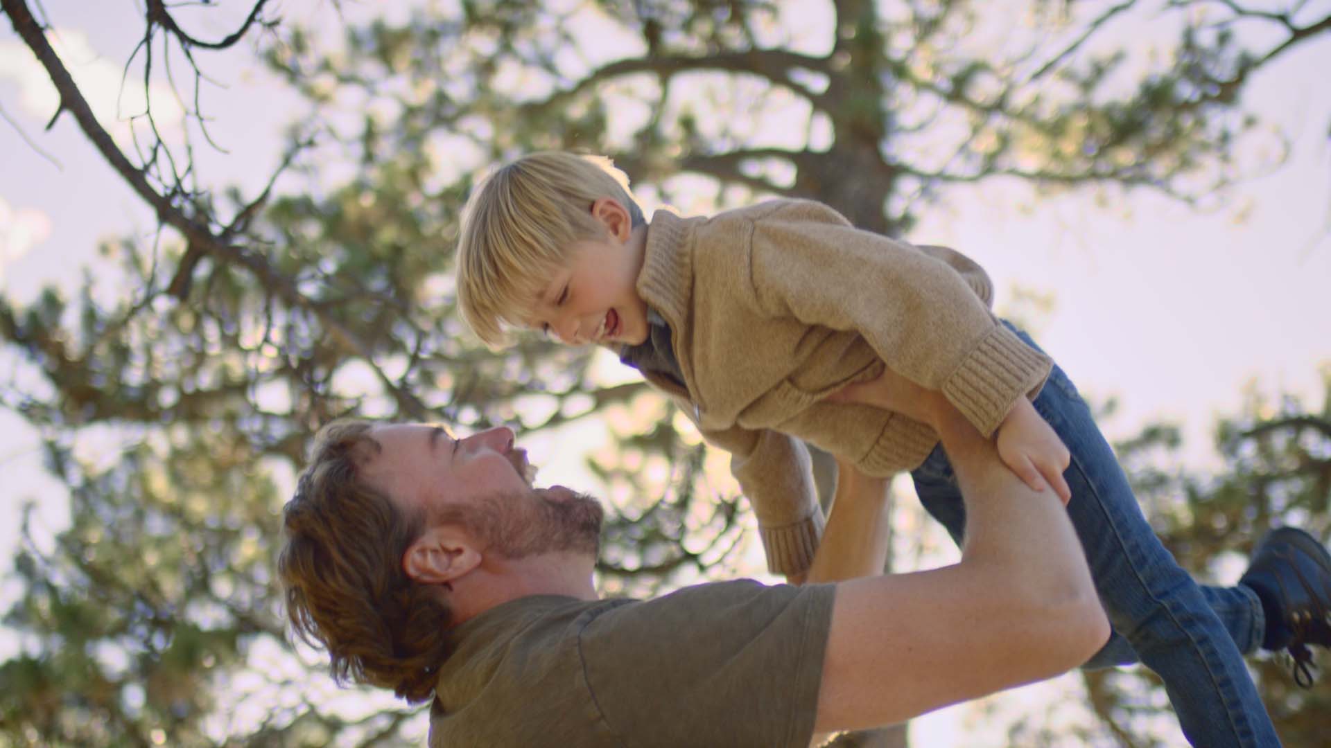 man lifting up child