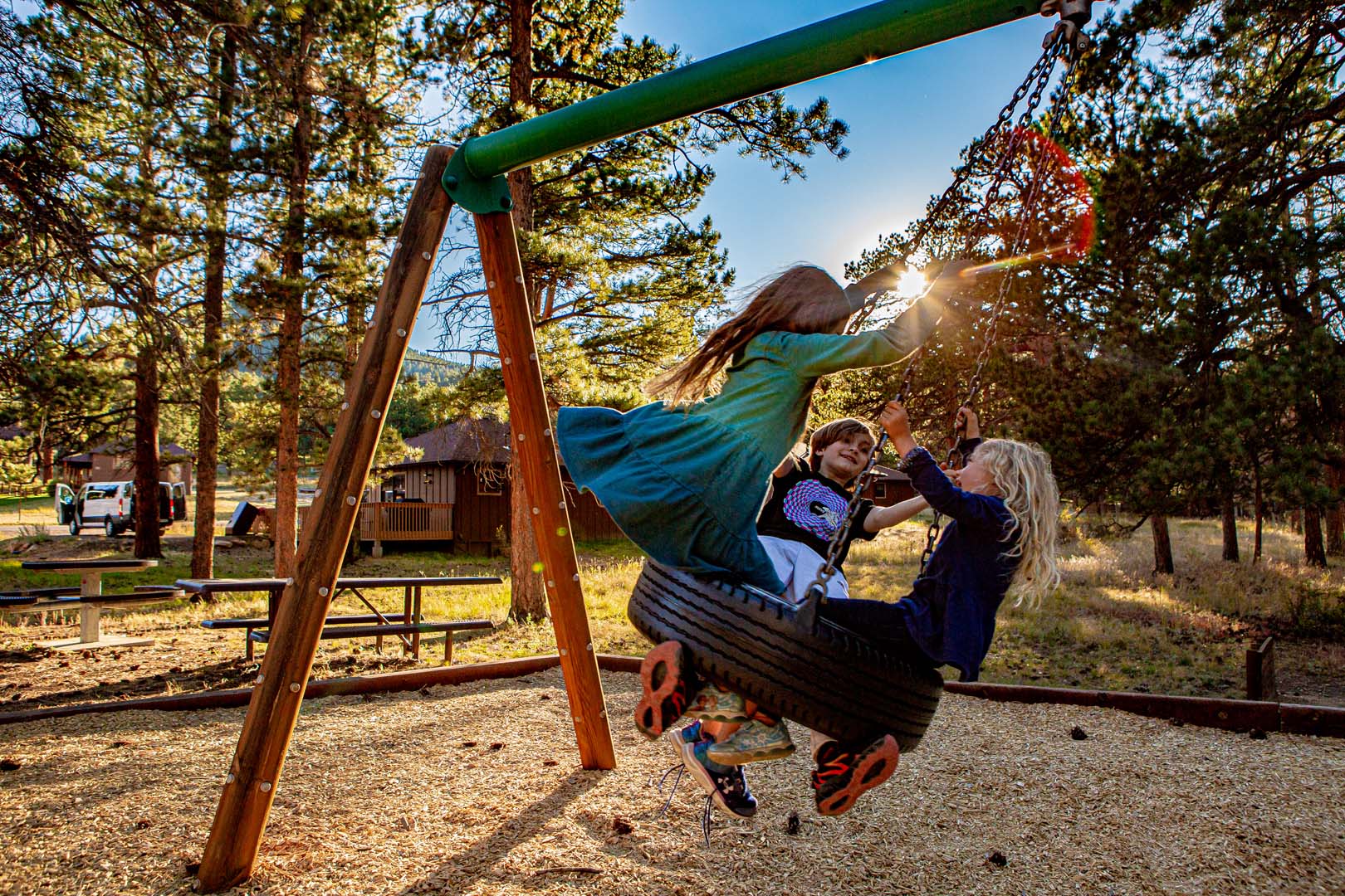 kids playing outside on a tire swing