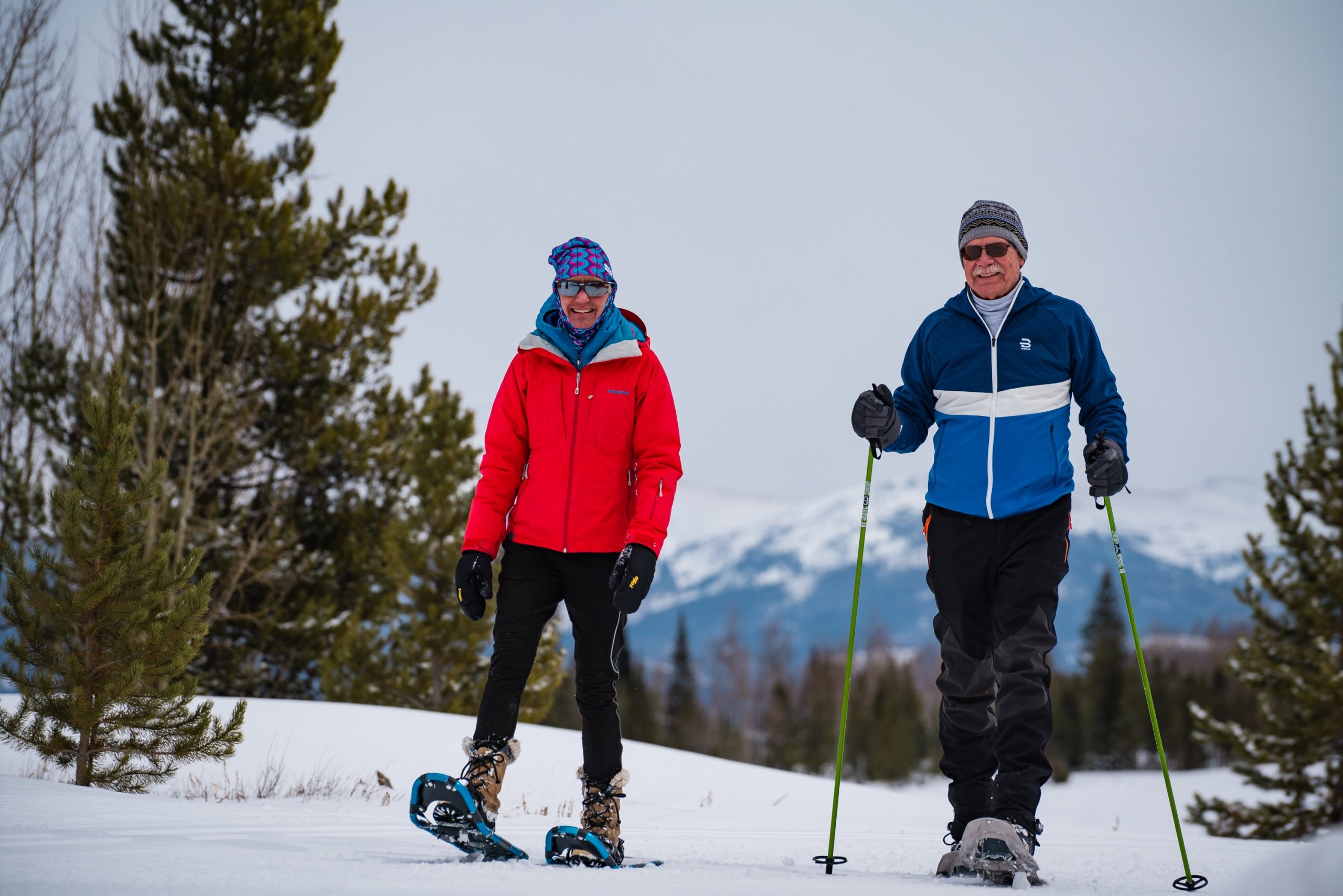 two elderly people on a ski mountain