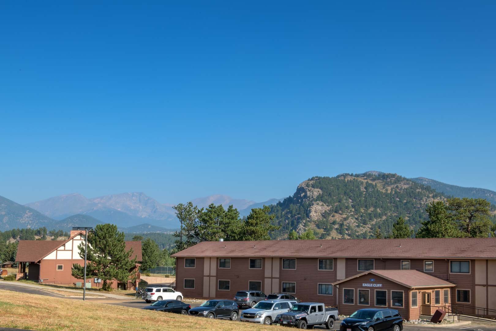 lodge with parking and mountains in background
