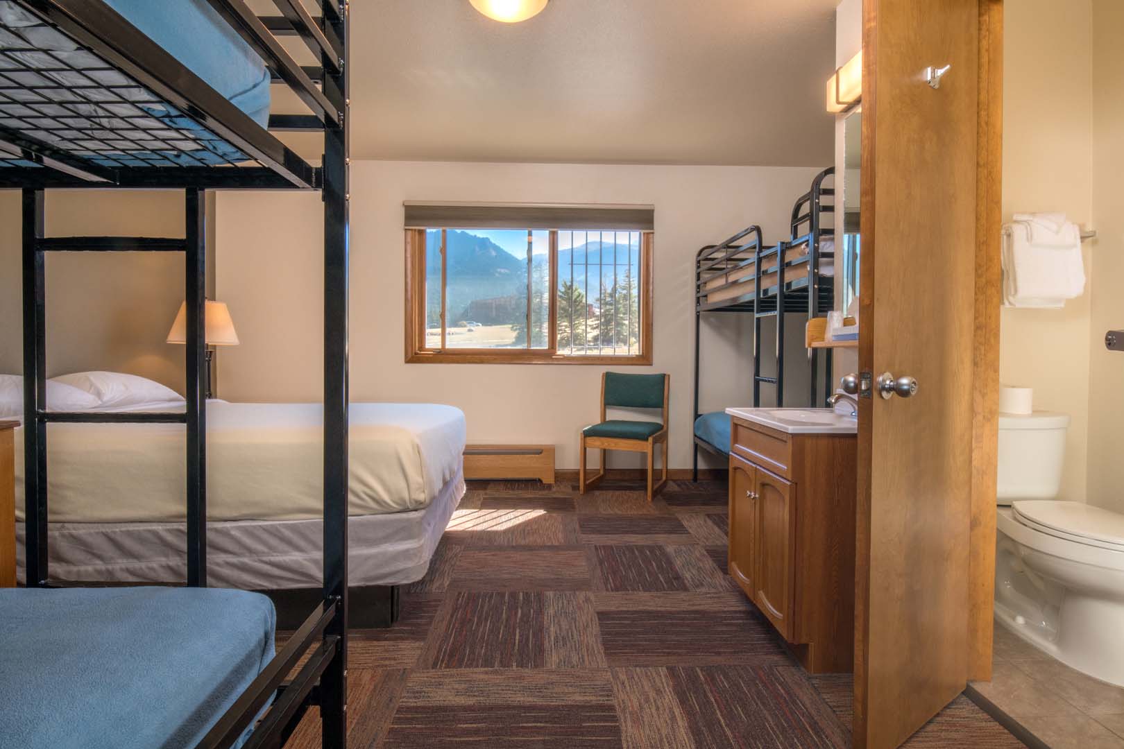 lodge room with queen bed and bunk beds