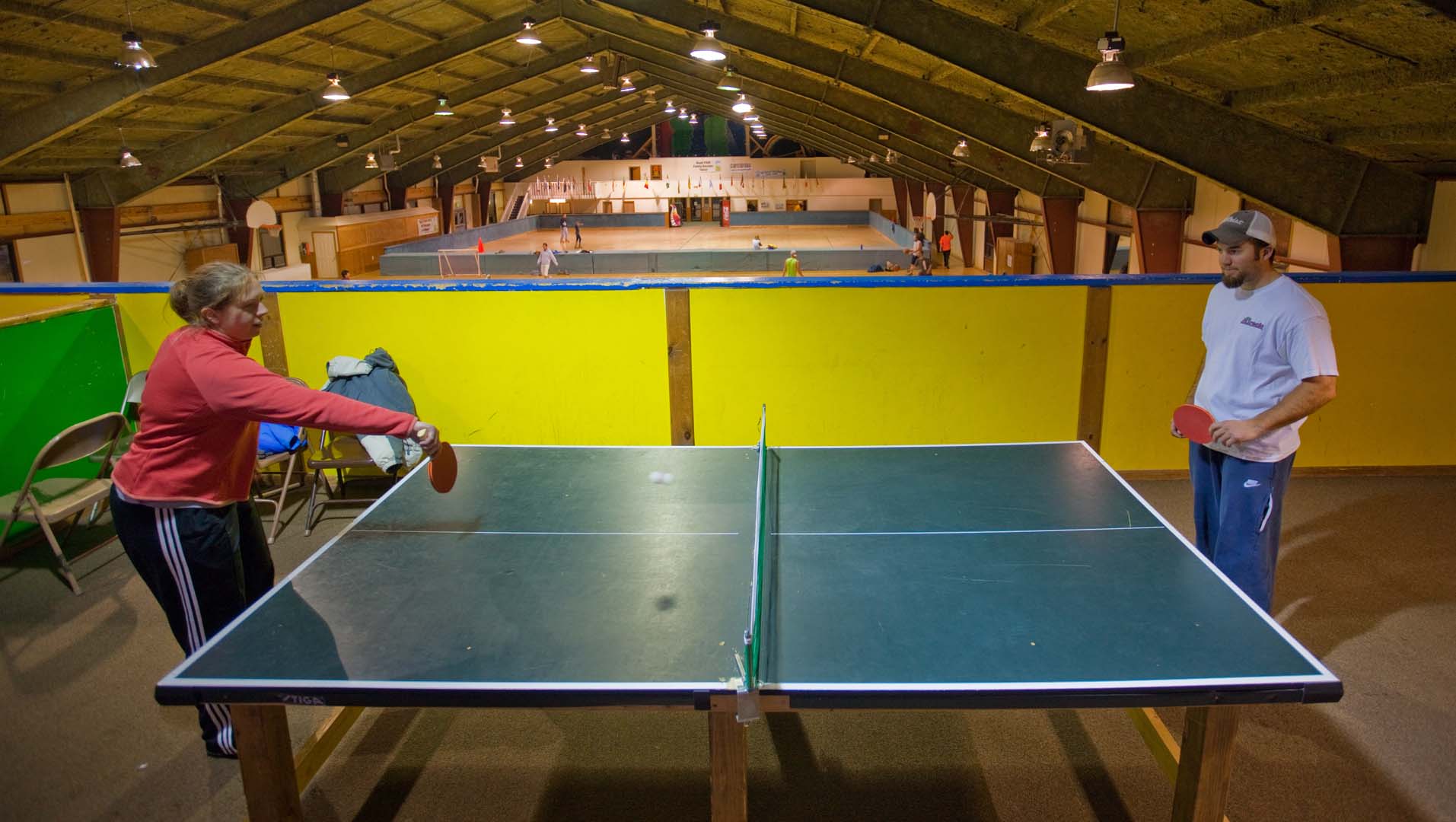 people playing ping pong in the game room