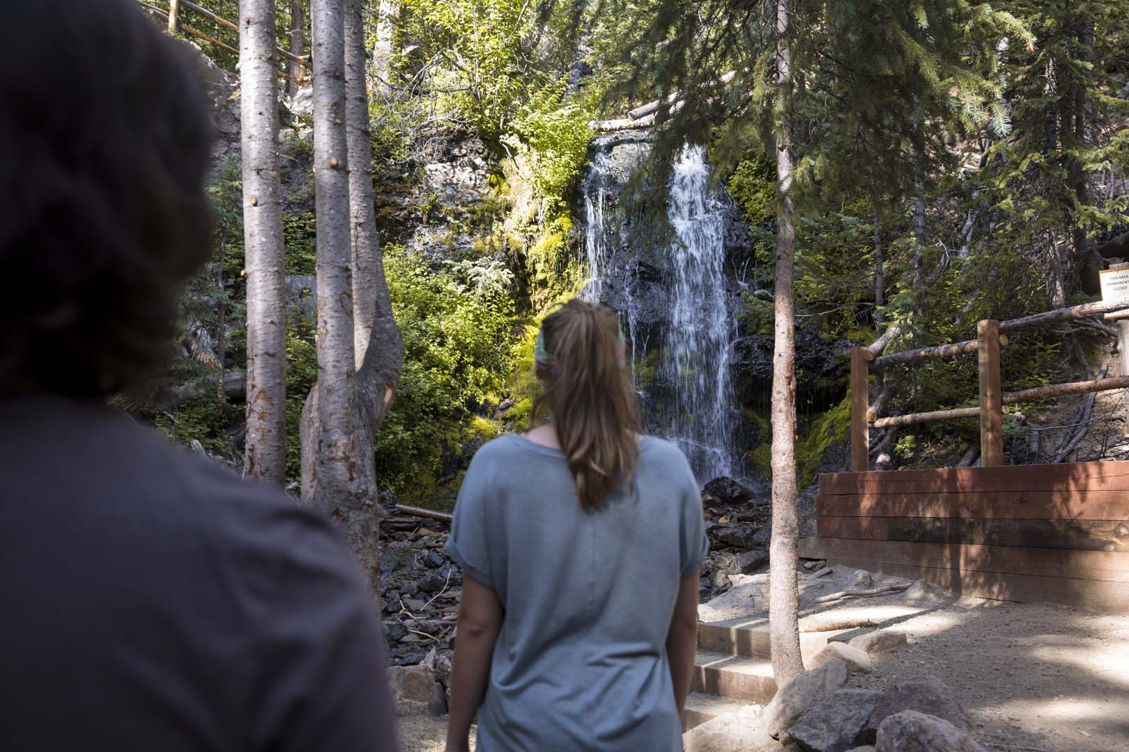 People hiking towards a waterfall