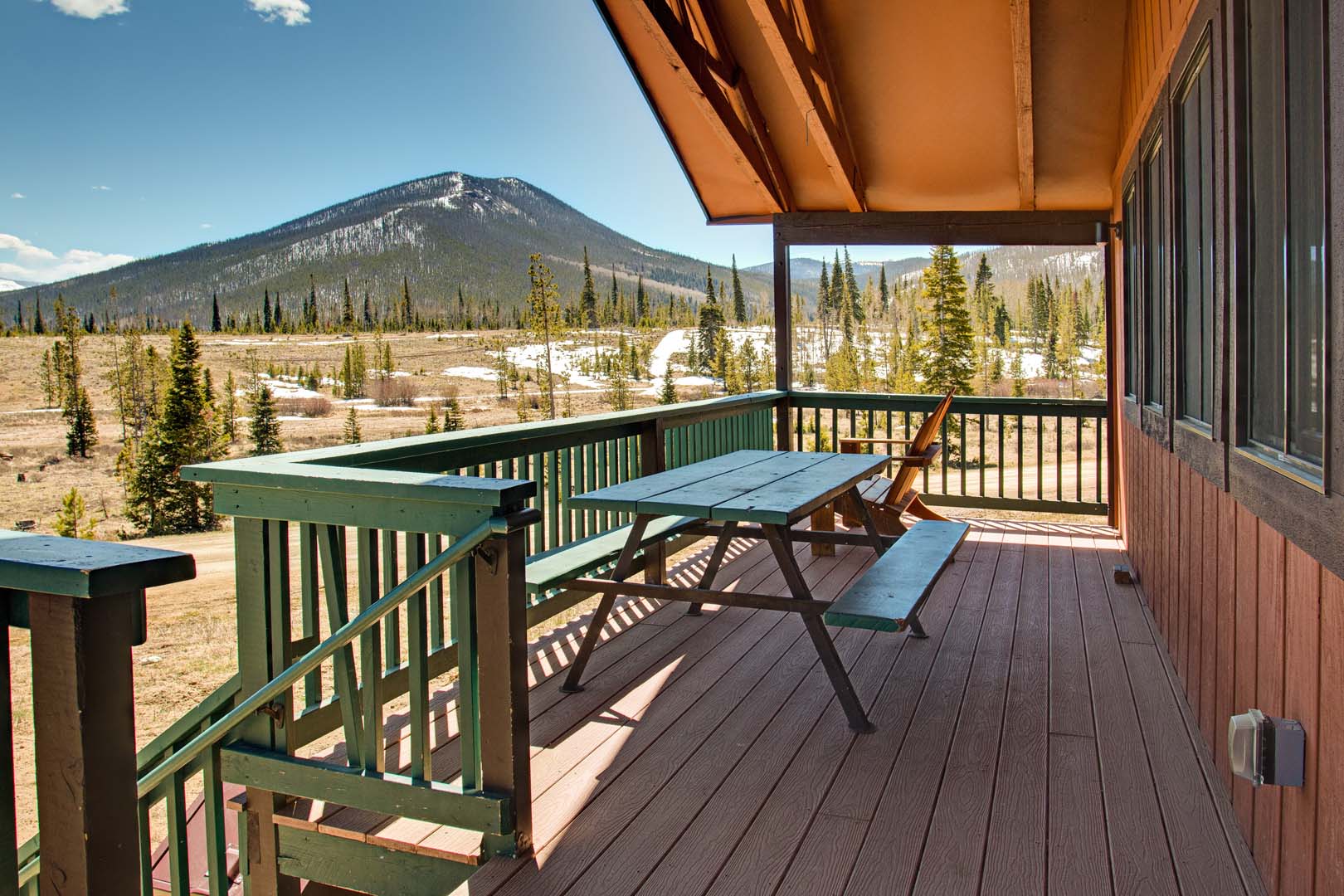 porch with picnic bench and view of mountain