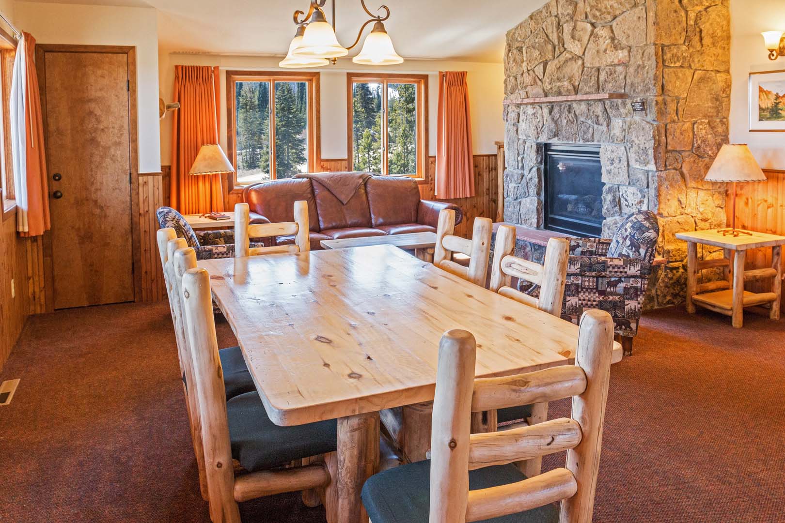 Living room with dining area, sofas, and fireplace