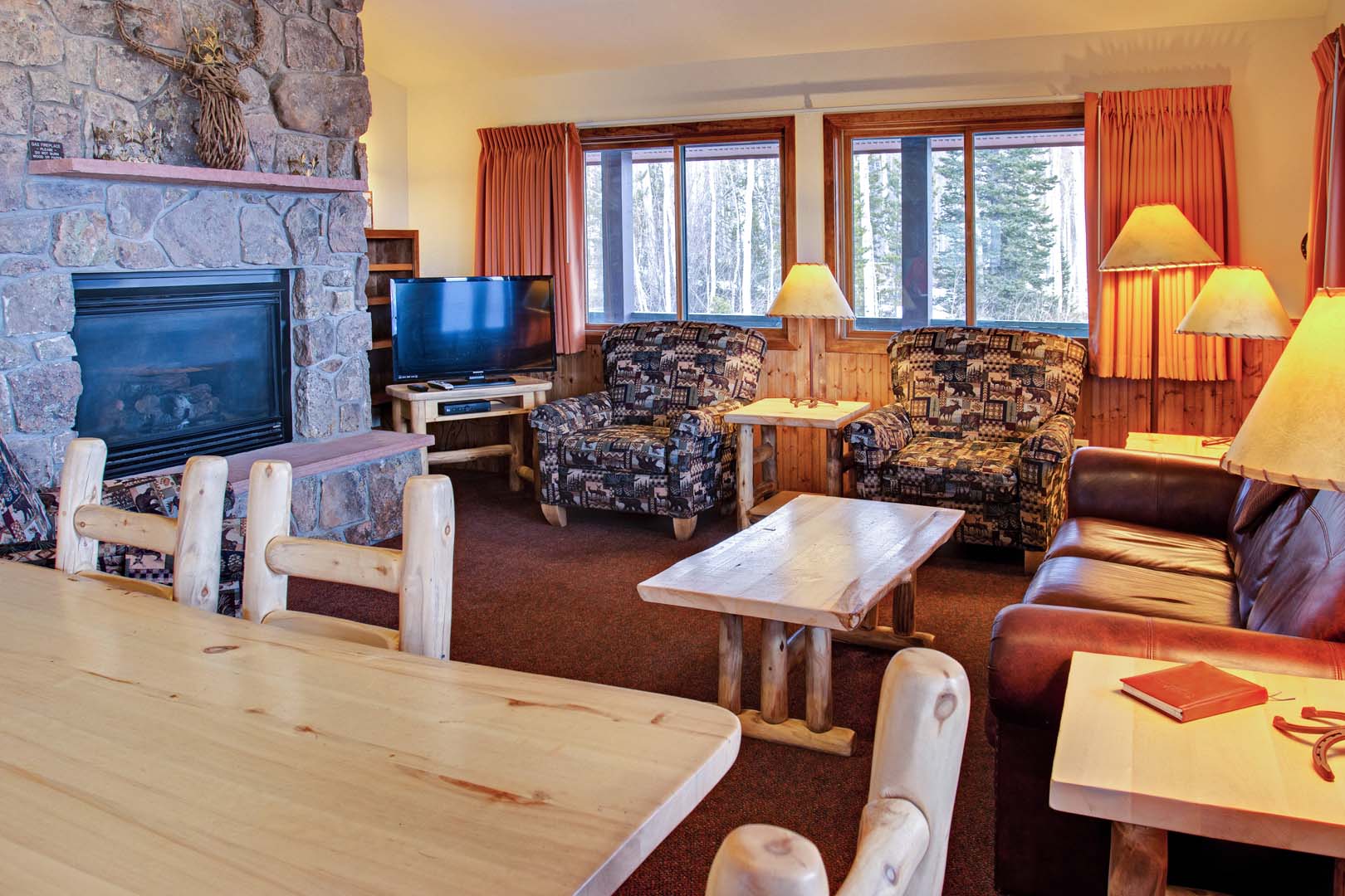 Living room with dining area, sofas, and fireplace