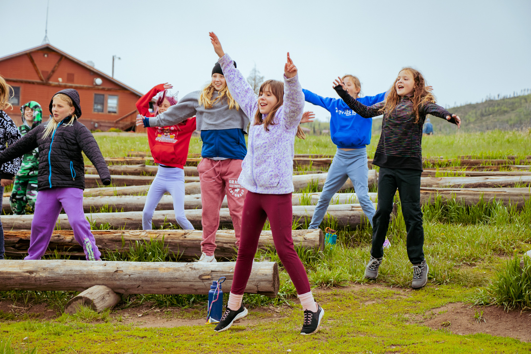 kids jumping at camp gathering