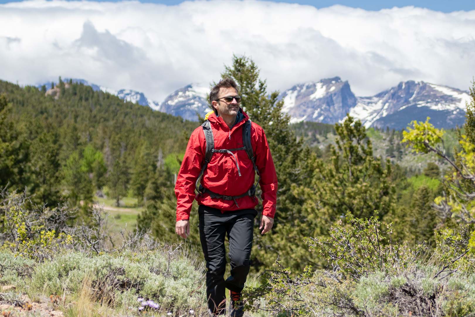 man hiking through trails