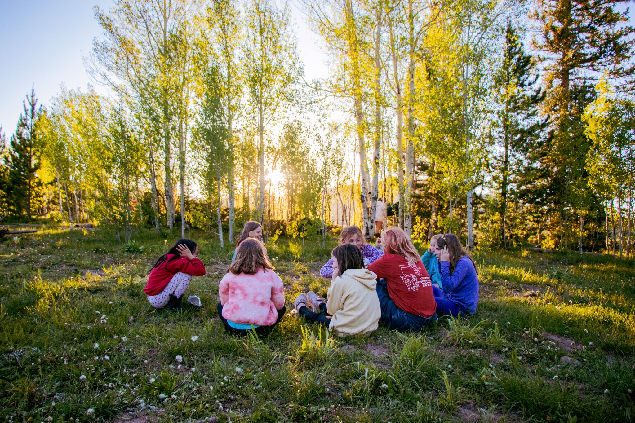 kids sitting in the forest