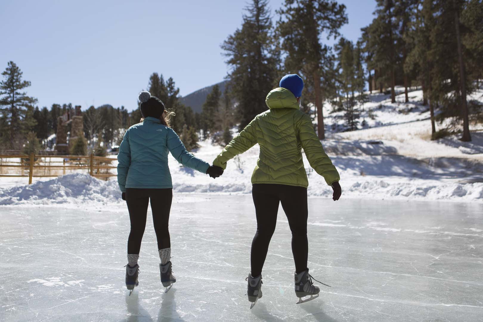 People skating and holding hands