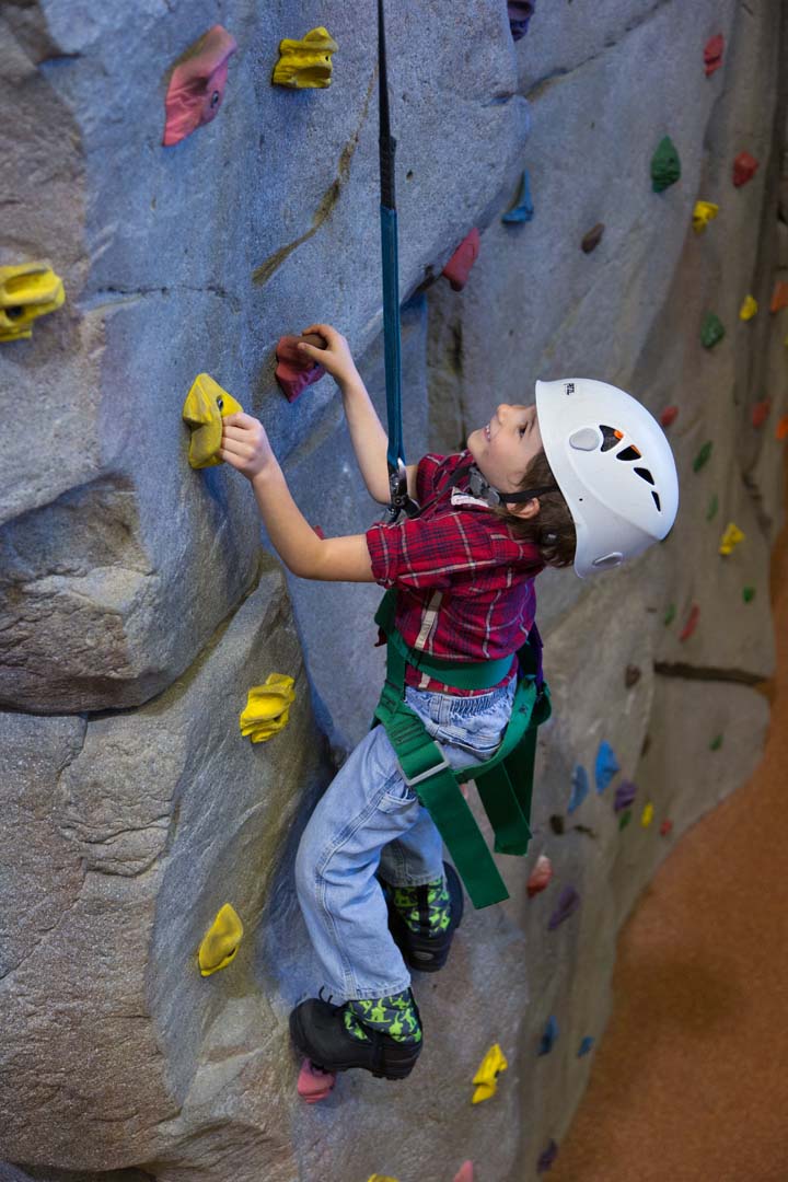 Child doing indoor rock climbing