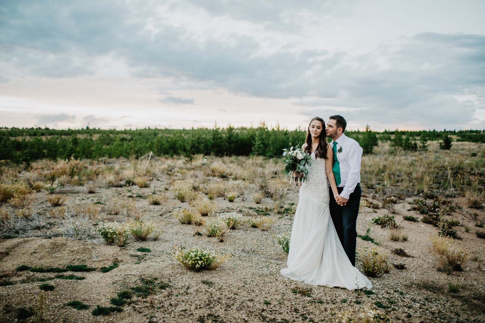 couple dressed for wedding in field