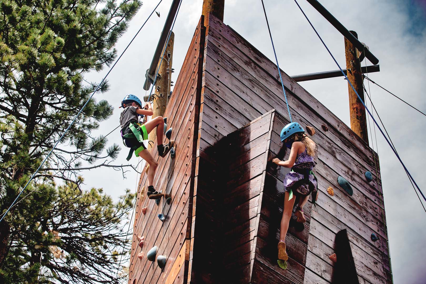 Children rock climbing outside