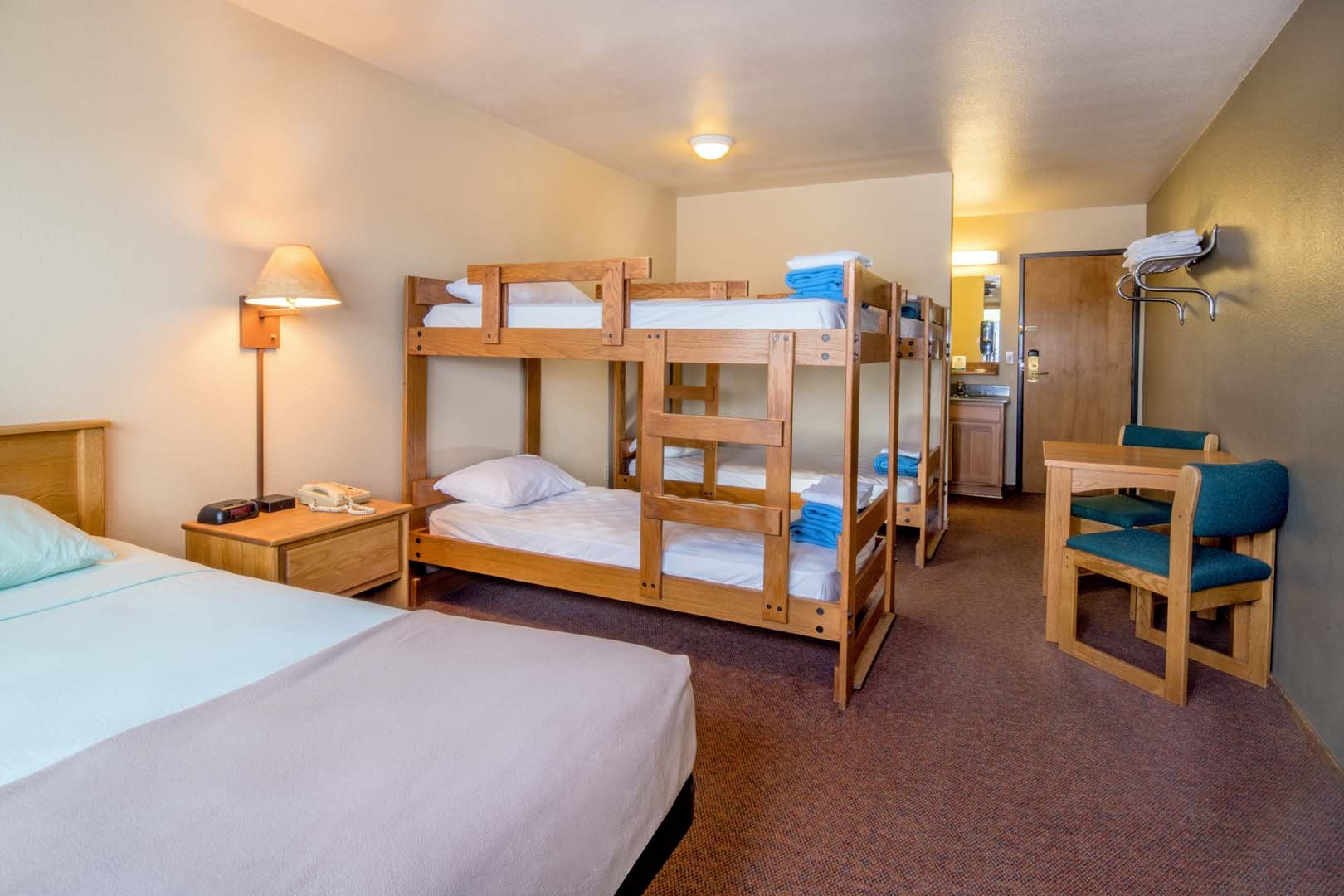 lodge room with queen bed and 2 sets of bunk beds