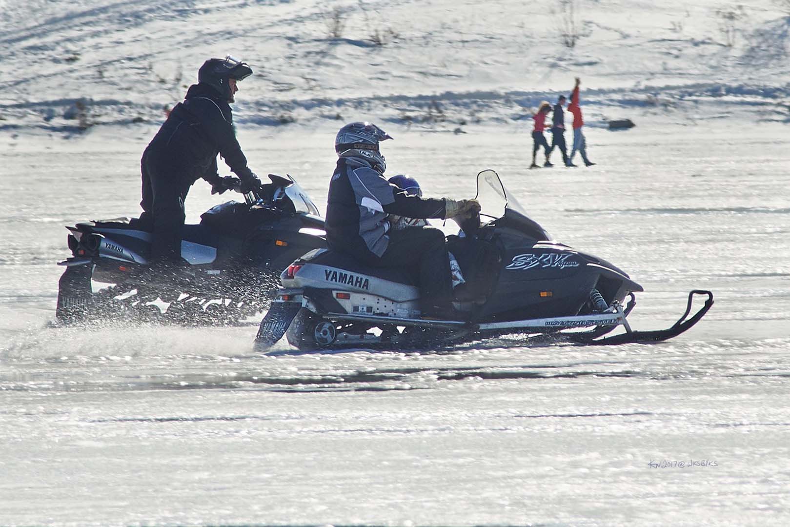 two people snowmobiling
