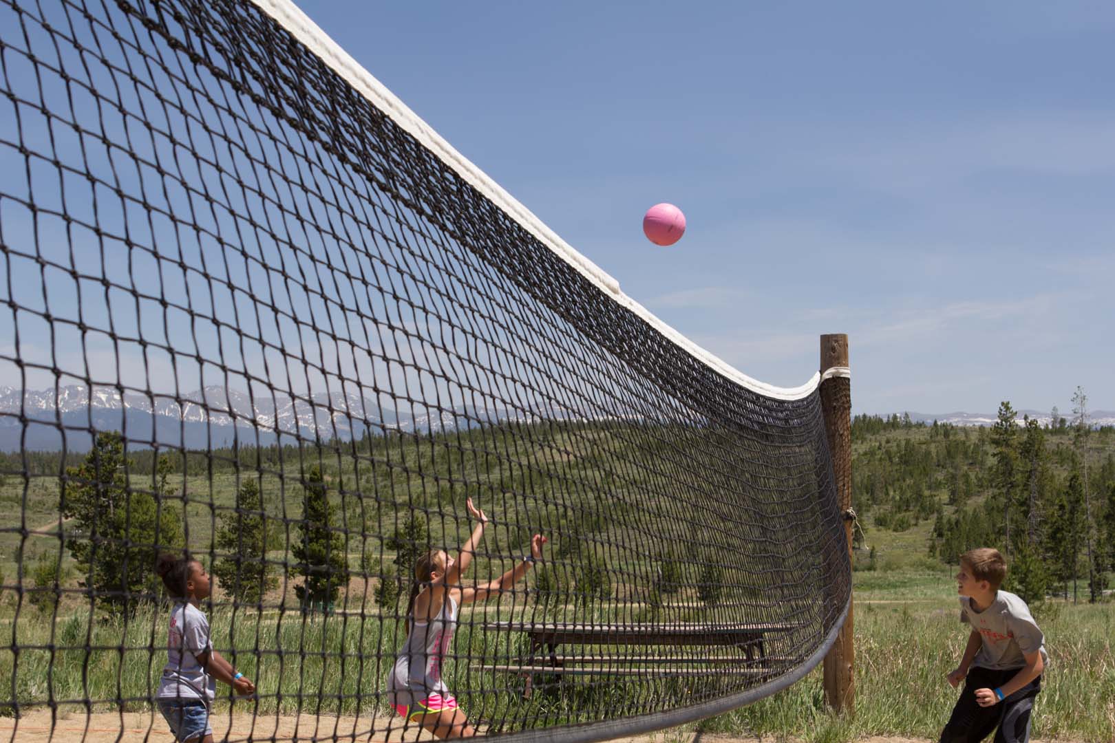 group playing sand volleyball