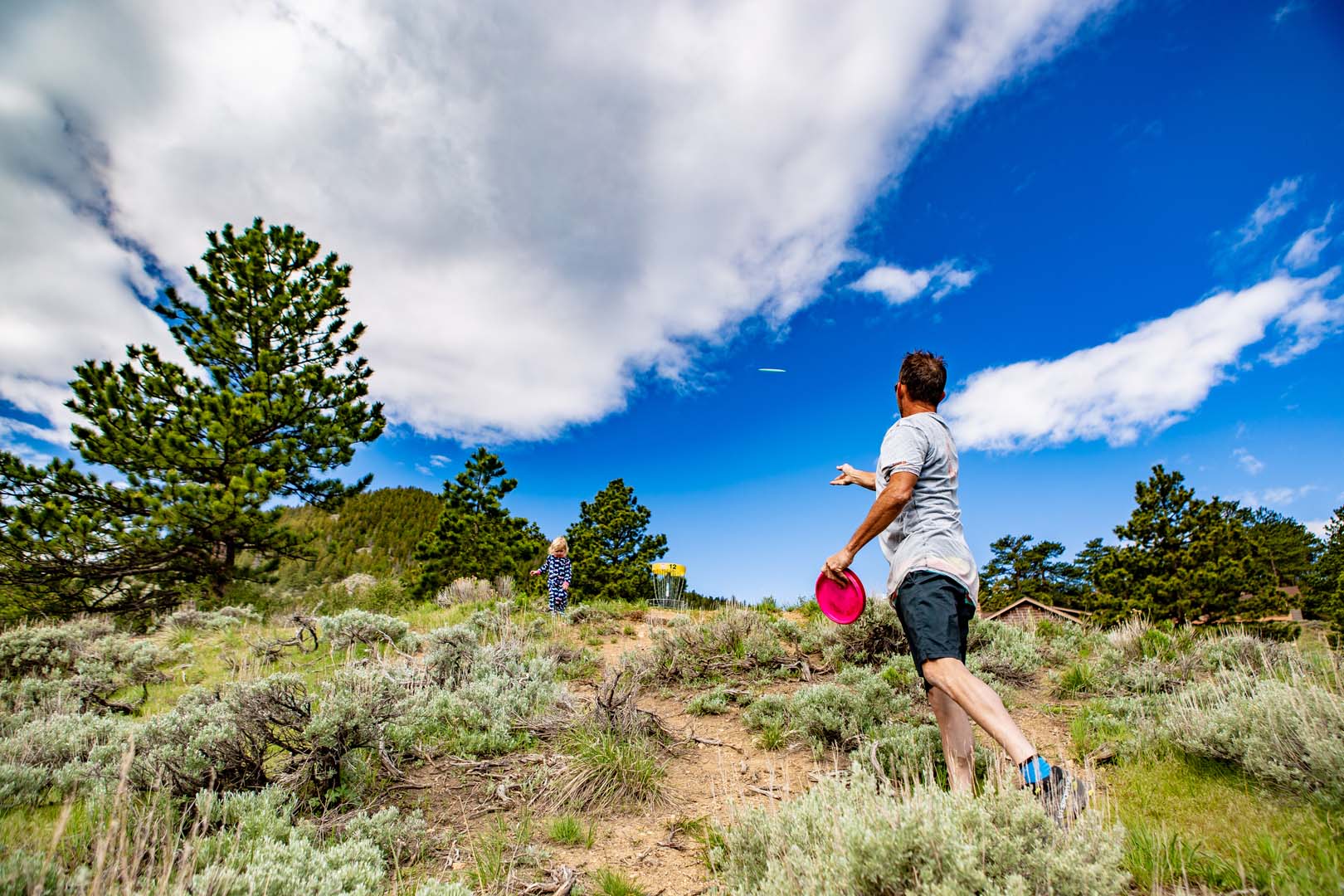 man and child playing frisbee