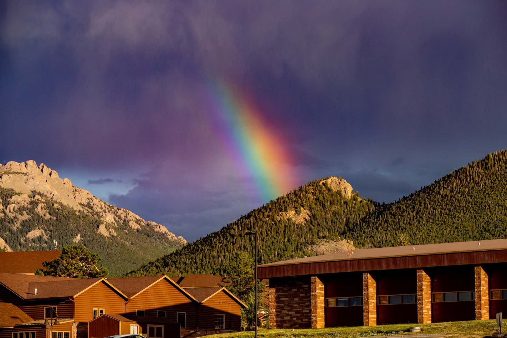 lodges with mountains and a rainbow