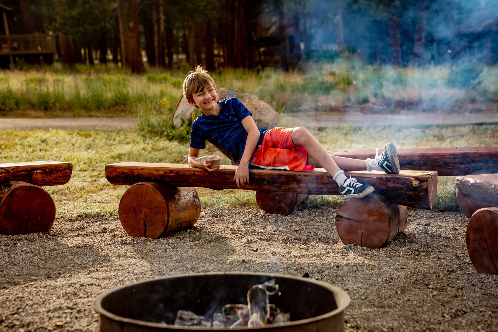 kid playing next to a camp fire