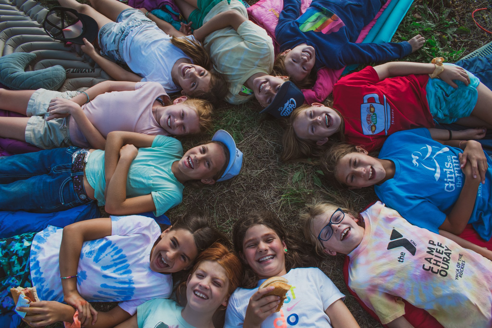 kids laying on the ground in a circle