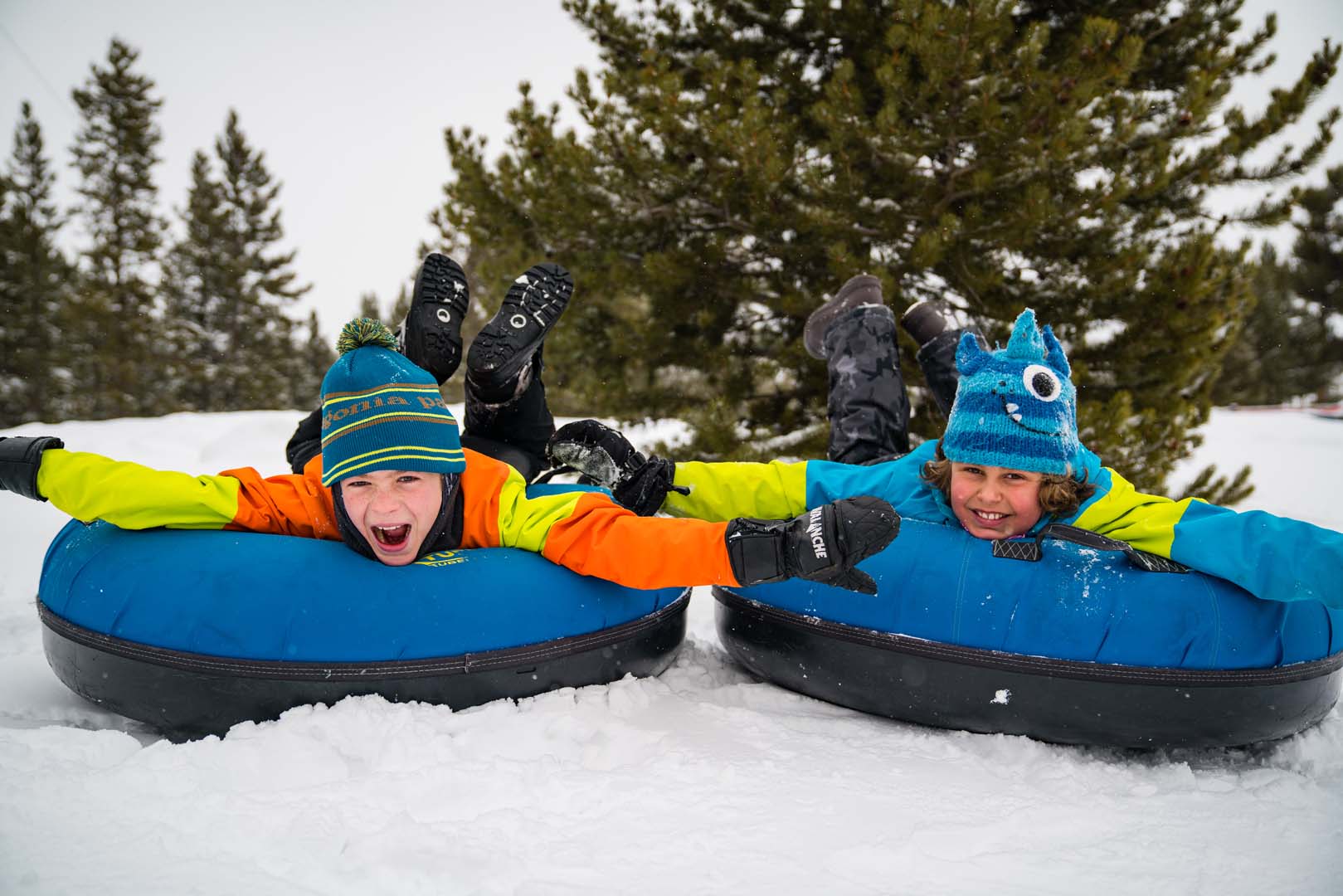 children tubing down the ski hill