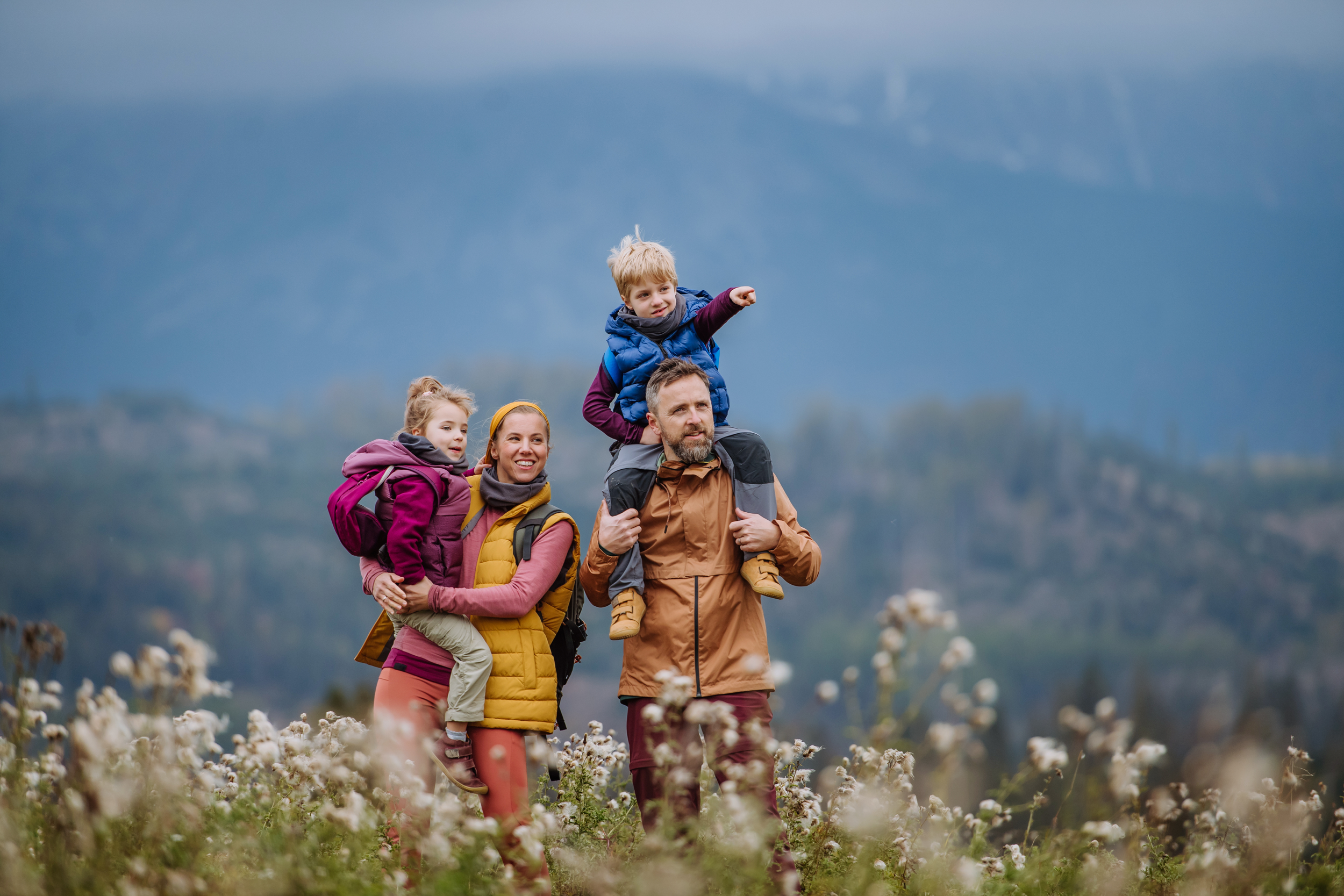 mother and father with two children hiking